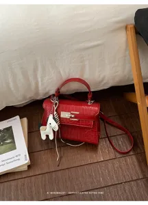 Red crocodile pattern PU leather handbag shoulder bag with chic horse charm detail.