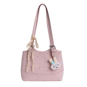 Pink leather shoulder bag with floral print, cute lace ribbon and plush bunny charm for women.