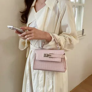 Chic pink crocodile pattern handbag for women, elegant leather top handle Kelly bag, stylish fashion.