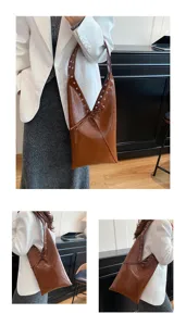 Vintage oil-wax leather shoulder underarm bag with metal grommets and tote design.