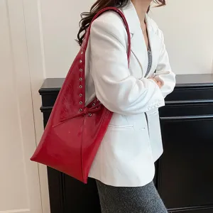 Red oil-wax leather shoulder bag for women, stylish underarm tote with metal rivet details.