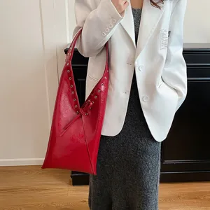 Red oil wax leather shoulder hobo bag with metal eyelets and knot detail for women fashion.