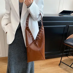 Retro oil-wax leather shoulder underarm bag with metal rivets and stylish side knot design.