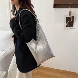 Silver metallic shoulder tote bag for women, stylish vintage hobo bag with trendy bow details.