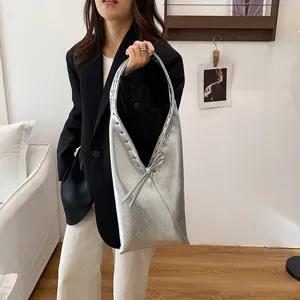 Silver metallic shoulder bag for women, trendy underarm purse with stylish rivet details and sleek design.