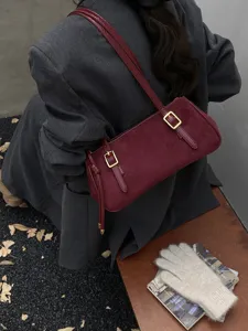 Stylish burgundy suede shoulder bag for women, chic buckle design, perfect commuter baguette bag.