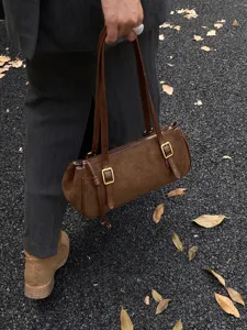 Brown suede shoulder bag for women, stylish cylindrical underarm purse for daily commute.