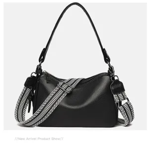 Black genuine leather shoulder bag for women, stylish crossbody pillow bag with wide strap.