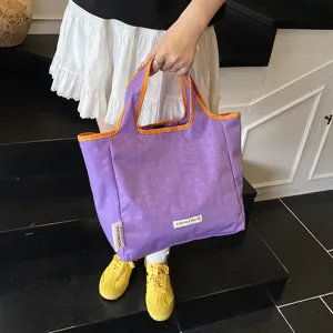 Purple canvas tote bag with orange trim, casual daily handbag and shopping pouch detail.