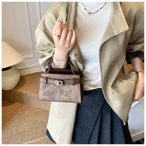 Detailed view of stylish contrast color top-handle handbag, elegant commuter design and chic charm.