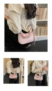 Detailed view of the stylish pink gathered shoulder bag with cute horse charm and smooth leather.
