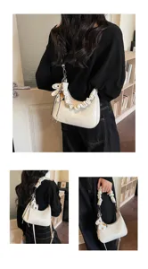 White leather ruched shoulder bag detail, stylish commuter tote with cute horse charm.