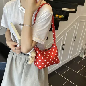 Red polka dot underarm shoulder bag with cute bear charm, stylish casual everyday fashion purse.