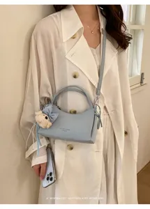Stylish light blue shoulder bag for women, trendy commuter crossbody bag with cute charm.