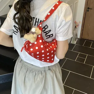 Red polka dot underarm shoulder bag for women, stylish niche design with cute bear pendant.