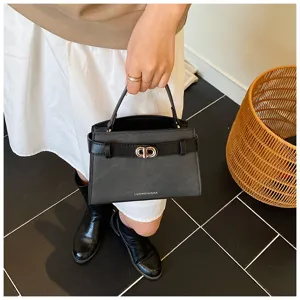 Black leather handbag detail, stylish strap buckle closure, elegant commuter bag view.