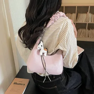 Pink shoulder bag for women, stylish hobo purse with pleated strap and cute horse charm.