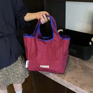 Casual contrast color canvas tote bag for women, stylish foldable portable shopping bag detail.