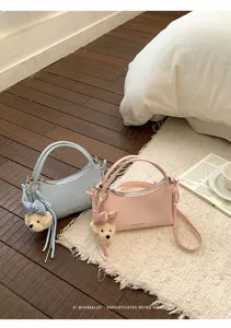 Detailed view of a chic minimalist shoulder bag with cute bear charm for daily commute.