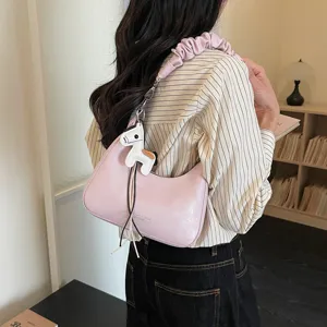 Stylish pink hobo shoulder bag for women with scrunchie strap and cute horse charm daily use