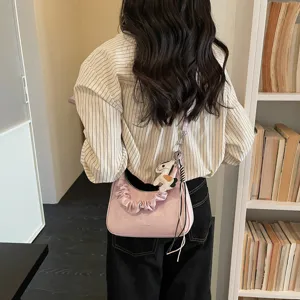 Women spring pink shoulder bag casual commuter handbag fashionable hobo bag with cute charm.