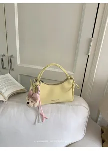 Chic yellow mini handbag with cute plush pendant, minimalist retro style shoulder bag for women.