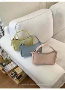 Detail view of minimalist PU leather handbag set, elegant retro style shoulder bag in pastel tones.
