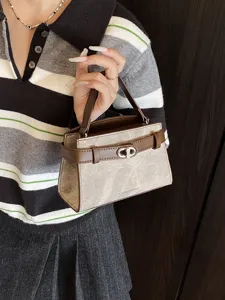 Chic contrast handbag for women, stylish color-block design with top handle and turn-lock.