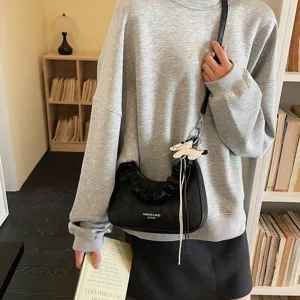 Black ruched shoulder bag for women, stylish hobo handbag with cute dog pendant and strap.
