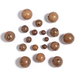Close-up detail of natural wood loose round beads with unique grain patterns for handmade DIY jewelry.