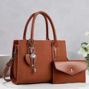 Brown women commuter shoulder bag detail showcasing premium PU leather texture and stylish key charm.