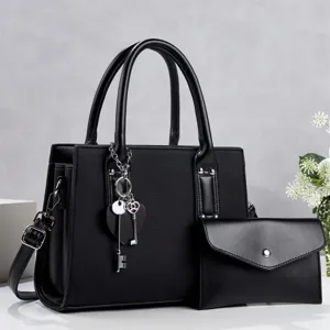 Black commuter women handbag set with shoulder strap and key charm detail view.