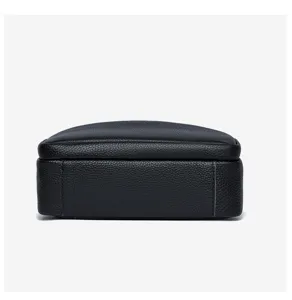 Black leather small crossbody bag detail view, soft genuine cowhide texture design close-up.
