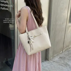 Spacious beige tote bag for women, stylish casual shoulder bag for daily commuting.