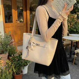 Casual large capacity tote bag for women, stylish commuter shoulder bag with charm.