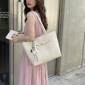 Spacious cream tote bag with elegant lock closure and chic charm for daily commute.