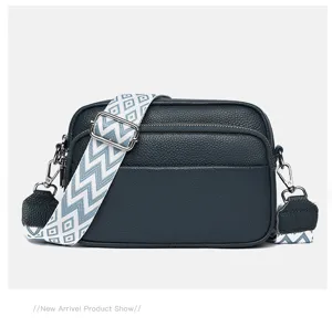 Stylish multi-layer women's shoulder bag with wide geometric strap for daily commuting.
