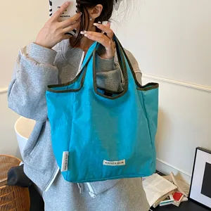 Detailed close-up view of bright blue canvas tote bag with dark trim for casual daily use.