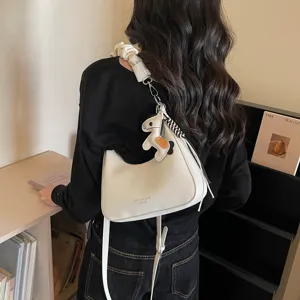 Stylish minimalist shoulder bag for women, premium hobo handbag with cute horse pendant detail.