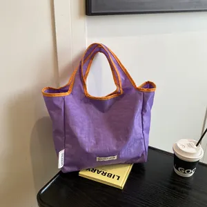 Purple casual tote bag with orange trim, portable foldable shopping bag for daily use details.
