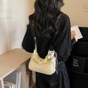 Casual yellow ruched shoulder bag with cute horse charm, stylish daily commuting handbag.