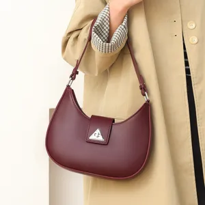 Women stylish maroon crescent underarm shoulder bag with metal triangle lock design.