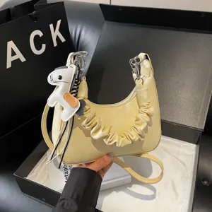 Yellow hobo shoulder bag with gathered strap and cute horse charm for daily casual commute.