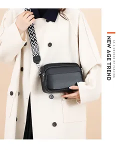 Black leather crossbody bag with wide geometric strap, multi-layer design for women daily use.