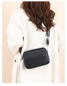 Multi-layer leather shoulder bag detail showing stylish black crossbody design and strap.