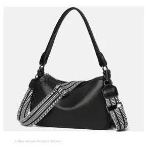 Stylish black leather saddle bag for women with wide strap, versatile casual shoulder crossbody bag.