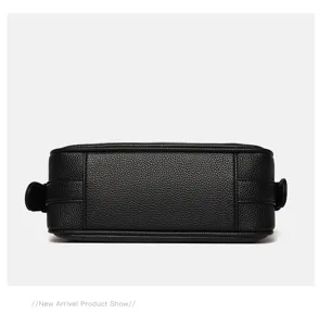 Black leather cross-body pillow bag detail view, stylish and versatile women's shoulder bag.