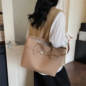 Detailed view of the stylish leather tote bag with elegant metal lock and shoulder strap.