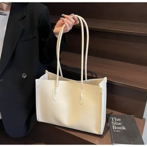 Detailed view of large capacity minimalist solid color shoulder tote bag in elegant cream.