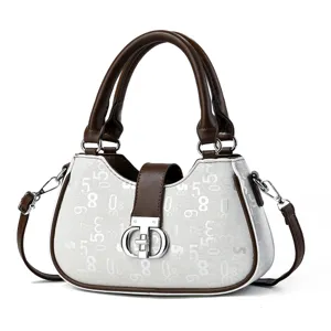Close-up detail of the luxury contrast color women handbag with digital print and metal clasp.